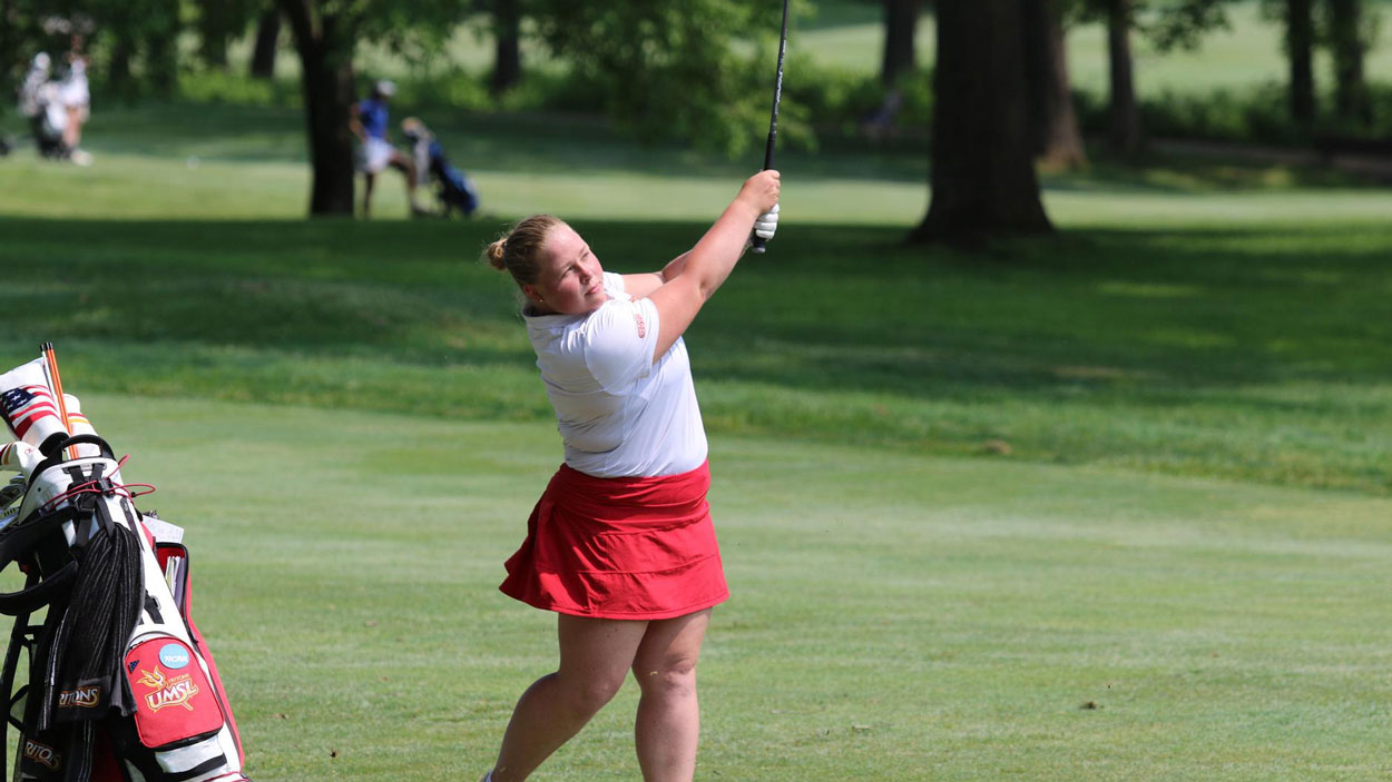 Wilma Zanderau finishes her golf swing after hitting a shot in the fairway