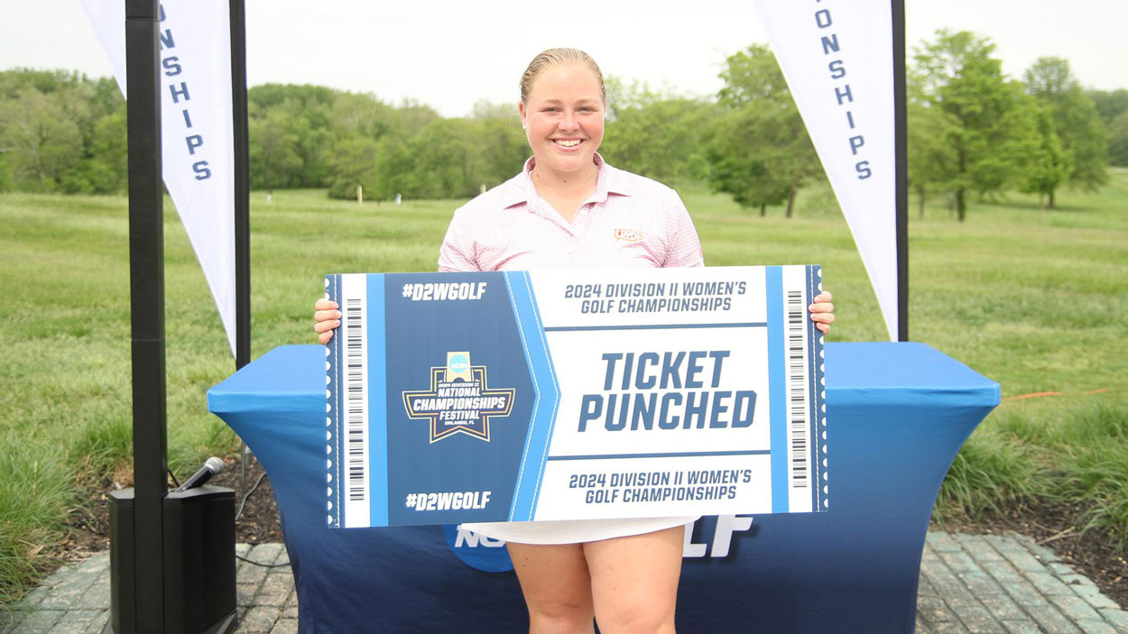UMSL women's golfer Wilma Zanderau holds a "Ticket Punched" sign after qualifying for the NCAA Division II Women's Golf Championship