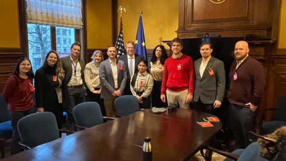 David Drinkard (center), UMSL alum and economic unit security chief for the U.S. Mission to the European Union, stands with a group of UMSL students and faculty members at the embassy in Brussels, Belgium