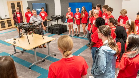 UMSL Geospatial Collaborative Director Reda Amer shows area high school students one of the drones in the Geospatial Advanced Technology Lab