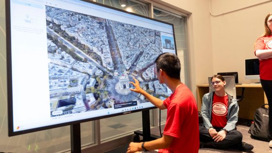 Ladue Horton Watkins High School student Aaron Lin manipulates a map of Paris with the Arc de Triomphe at the center on the interactive table in the Geospatial Advanced Technology Lab