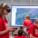 Affton High School student Allyson Meyer wears a virtual reality headset in the Geospatial Advanced Technology Lab.