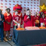 Chancellor Kristin Sobolik speaks, surrounded by alumni, students, faculty and staff, during a Red and Gold Day celebration in the Millennium Student Center as the UMSL community gathers to mark the 60th anniversary of the university's founding
