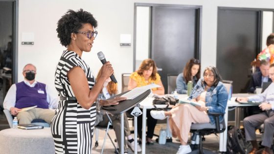 St. Louis Anchor Action Network Director Stefani Weeden-Smith welcomes out-of-town guests to the opening session of the Anchor Learning Network Action Summit last Monday at Refuge and Restoration Marketplace in Dellwood.
