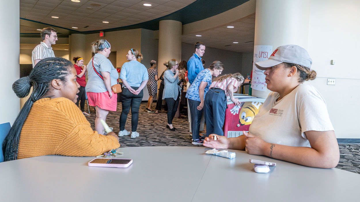 Staff members Amari Cunningham and Jasmine Moore talk and enjoy their frozen treats during an ice cream social sponsored by the UMSL Human Resources last week in the Millennium Student Center