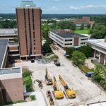 A drone captures a photos of large construction equipment parked in the cleared out Quad at the University of Missouri–St. Louis last week as the deconstruction of the Social Sciences and Business Building Tower moves forward.