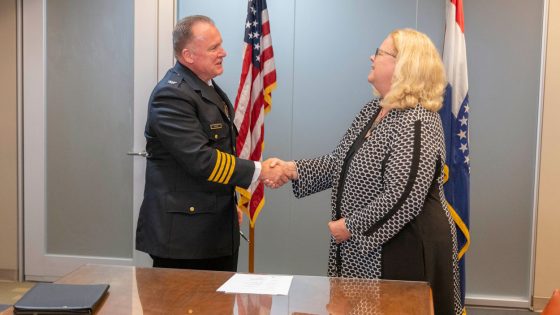 St. Louis Metropolitan Police Department Commissioner Robert Tracy shakes hands with UMSL Chancellor Kristin Sobolik after the two signed an educational partnership agreement Thursday afternoon at the department's downtown headquarters.