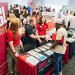 Members of the UMSL Accounting Club, including master's students Angela Truesdale and Thomas Fabry and Associate Teaching Professor in Accounting Marcia Countryman, speak with students