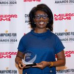 St. Louis Anchor Action Network Director Stefani Weeden-Smith holding her Champions for Diversity and Inclusion Award from the St. Louis Business Journal