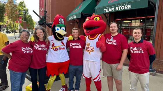 Adella Jones, Katy Mike Smaistrla, Fredbird, Justin Simard, Louie the Triton and Alexander Orywall outside the entrance to the Cardinals Team Store at Busch Stadium