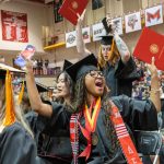 UMSL nursing students show their exuberance to the audience after receiving their diplomas at commencement