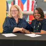 University of Missouri–St. Louis Chancellor Kristin Sobolik shakes hands with Girl Scouts of Eastern Missouri CEO Natissia Small after signing an educational partnership agreement on Oct. 29