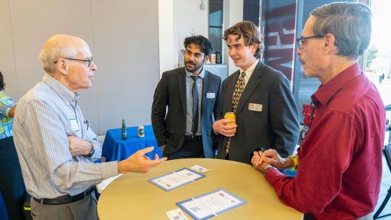 Norm Eisenberg, a Coro Fellow from the program's second St. Louis class in 1974-75, talks with current Coro Fellows Alawi Masud and Carter Stacy and Coro Neighborhood Leadership Program participant Craig Schmid.