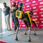 Elijah McCoy (center) and Jalen Walker-Wright from the Office of Student Involvement help kick off the official launch of an initiative to help name UMSL Geospatial Collaborative's agile mobile robotic dog on Tuesday afternoon at The Nosh.