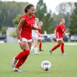 Women's soccer player Jada Holloman dribbles the ball