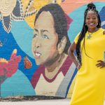 Felice McClendon standing in front of a mural along Delmar Boulevard