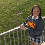 UMSL student Jay King leans against railing