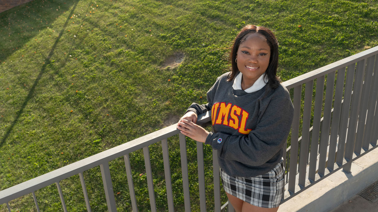 UMSL student Jay King leans against railing