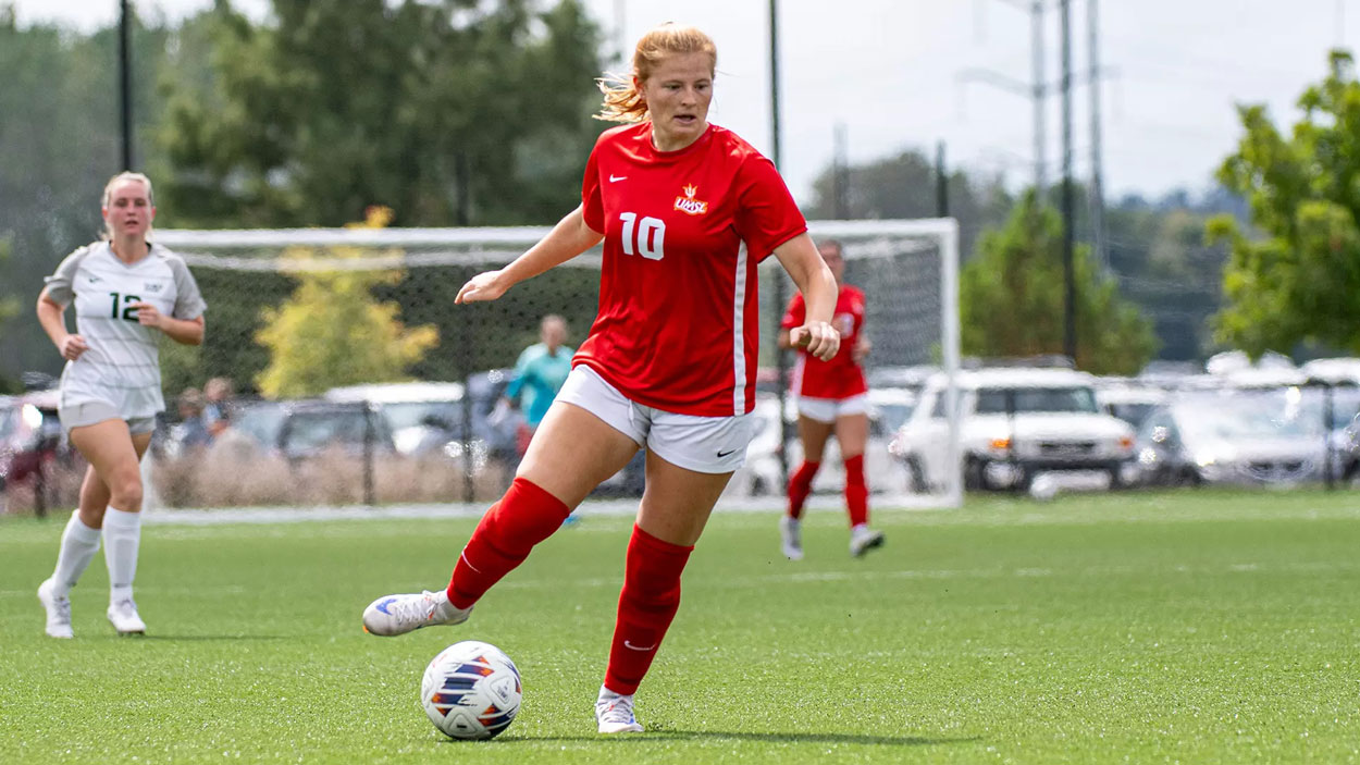 Senior midfielder Kayley Judy dribbles a soccer ball in the open field