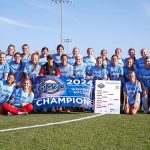 Members of the UMSL women's soccer team holding the Great Lakes Valley Conference Tournament championship trophy