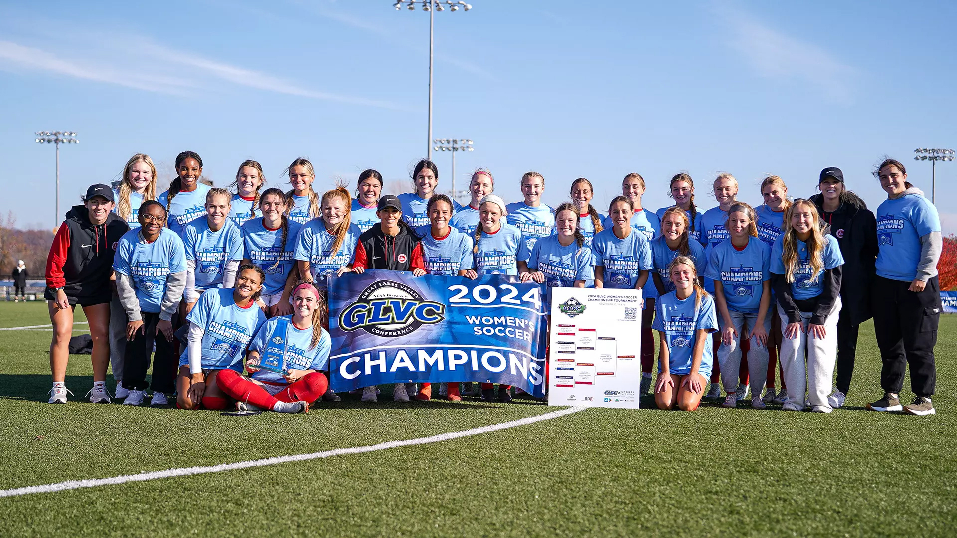 Members of the UMSL women's soccer team holding the Great Lakes Valley Conference Tournament championship trophy