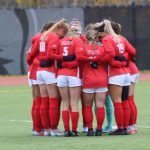 UMSL's women's soccer team huddles together