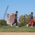 Runners participate in 5K with tower in background