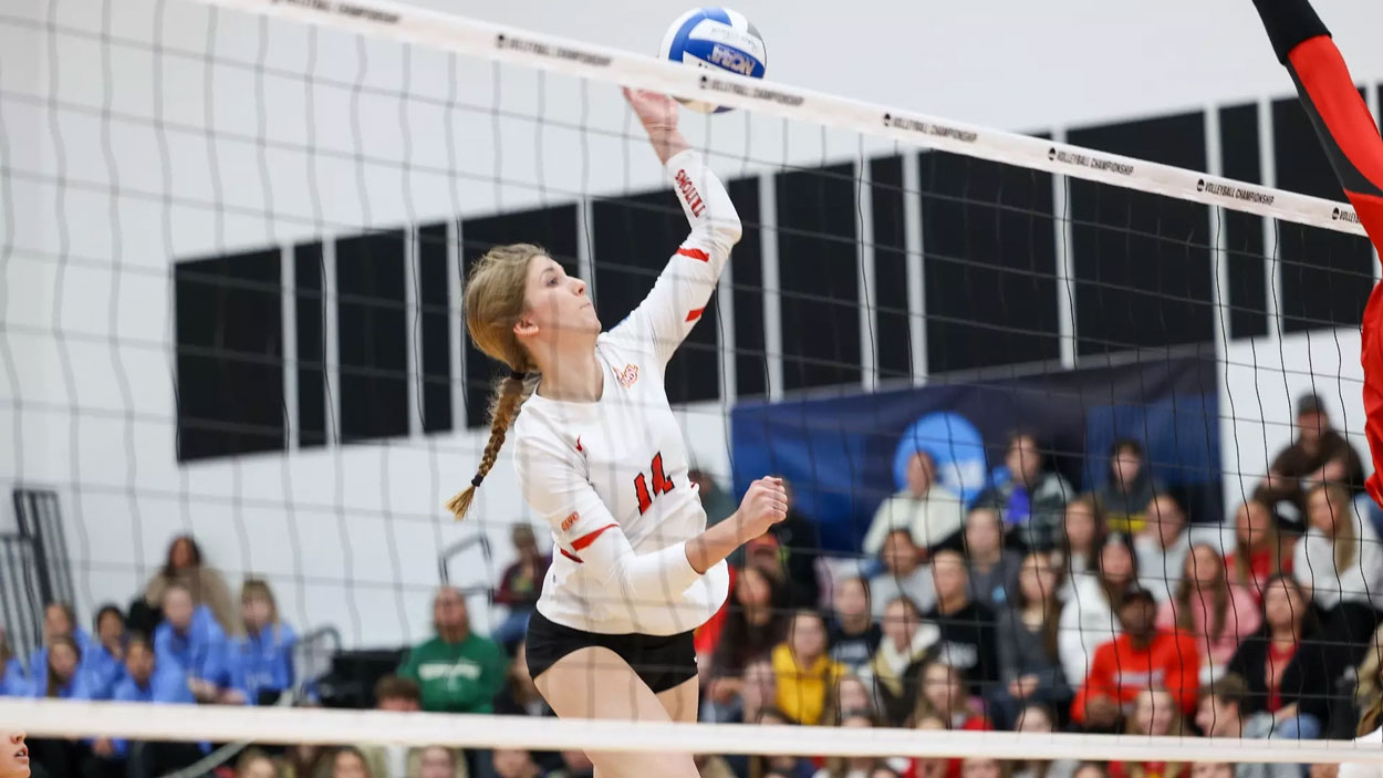 Rightside hitter Alayna Santel swings at a ball while leaping at the net