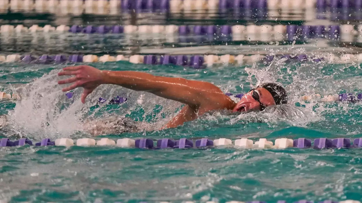 Fifth-year senior swimmer David Reynolds swims in a freestyle race