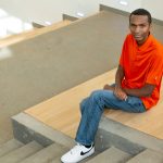 Kordell Hamilton sitting on the steps in the Science Learning Building