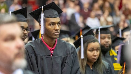 Biology graduate Kordell Hamilton, dressed in his cap and gown, listens intently during the commencement ceremony