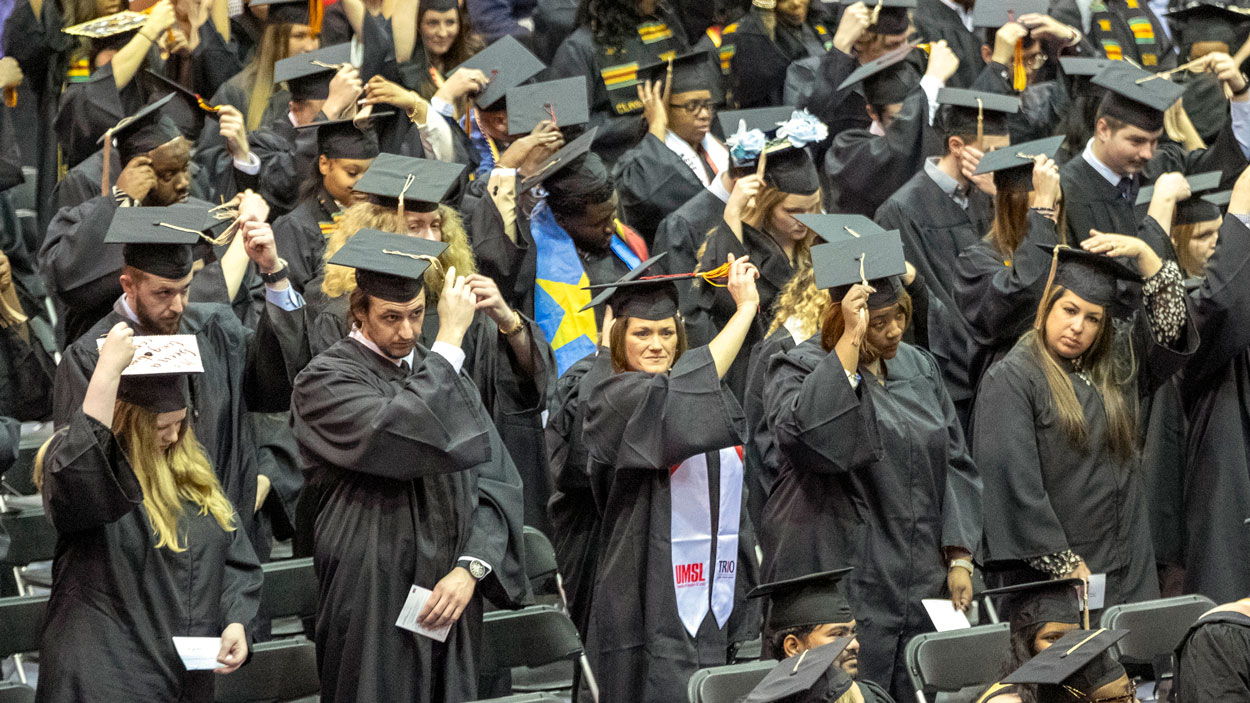 New graduates move their tassels from the right to the left near the end of Saturday's ceremony.