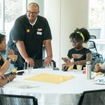 TRIO Student Support Services Director Harry Harris talks to a group of first-generation college students at a welcome breakfast before the start of the fall semester.