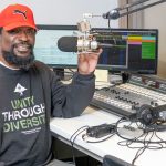 Christopher Brooks sitting at the microphone in the UMSL Radio studio