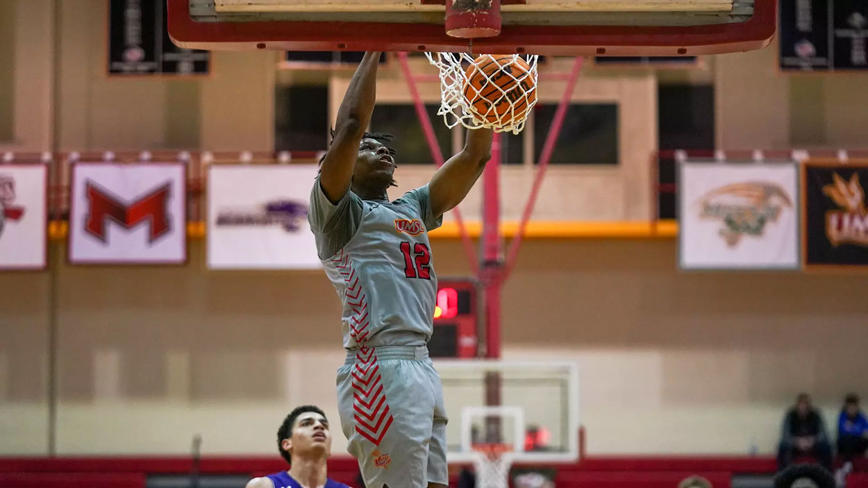 Emanuel Prospere II dunks a basketball