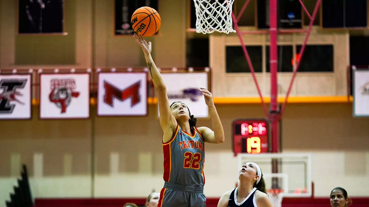 Mara Rieder shoots a layup as a defender looks on