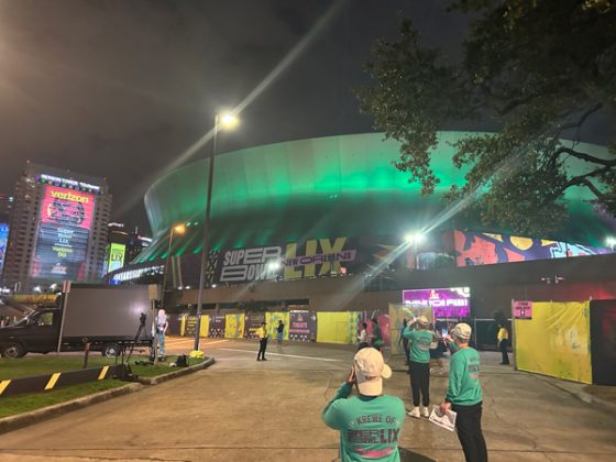 Caesars Superdome lit with green lights