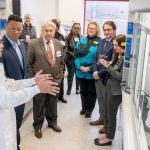 Chinh Ngo, a senior process chemist at the API Innovation Center, leads a tour of the new research and development labs that opened Monday in UMSL's Science Complex. Among those taking the tour were (from left) Sen. Brian Williams, UMSL Vice Chancellor Chris Spilling, Ferguson Mayor and UMSL alum Ella Jones, state Rep. Marla Smith, UMSL Chancellor Kristin Sobolik, and APIIC Founder and Chair Tony Sardella.