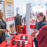 Renita Miller, the program manager for the University of Missouri–St. Louis International Business Institute, speaks with students Lexe Sullivan and Nicole White Campbell during the College of Business Administration's Majors/ Minors Fair last Thursday on the first floor of Anheuser-Busch Hall