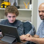 Yosef Granillo and Associate Professor Badri Adhikari discuss edits to a research paper