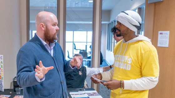 Stephen Bagwell discusses study abroad opportunities with senior philosophy major Olajuwon Davis during UMSL Global's Study Abroad Fair.