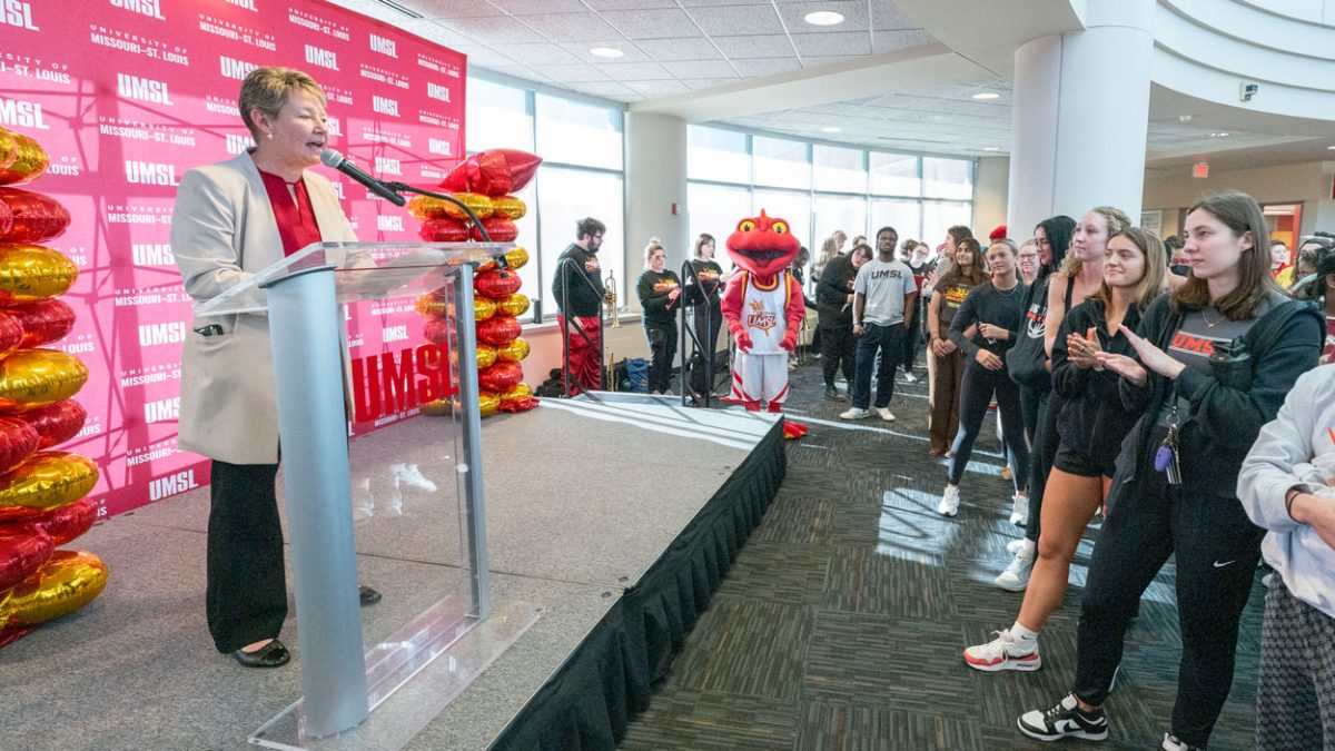 Executive Director of Athletics Holly Sheilley speaks during a pep rally to introduce the new Louie logo design