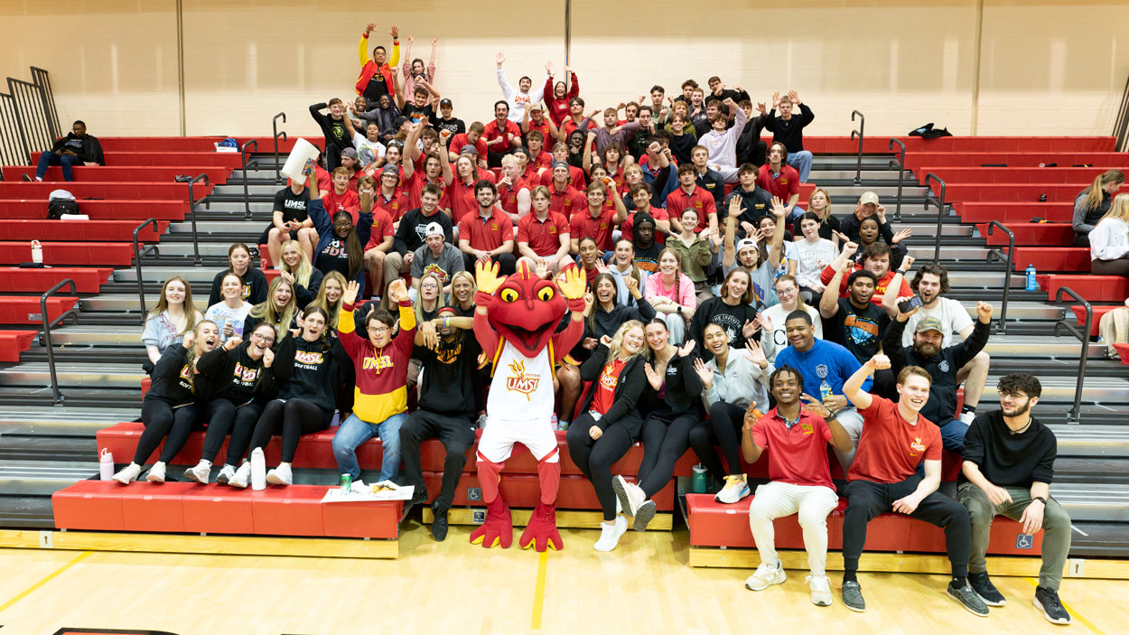 Students pose with Louie during the 2025 Pack the Stands event