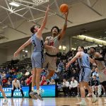 Janeir Harris leans around a defender to put up a left-handed layup against Upper Iowa at Lindenwood's Hyland Arena