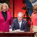 Chancellor Kristin Sobolik and St. Louis County Council Chair Rita Heard Days watch as County Executive Dr. Sam Page signs a bill directing $10 million to support the North County Business and Workforce District being planned on UMSL's South Campus.