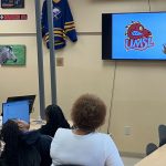 Traci Moore talks to Cardinal Ritter College Prep students about the new Louie logo