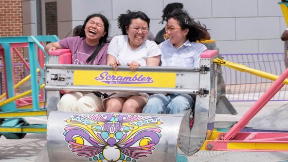 students Cing Niang, Linda Lam and Carli Knopf ride the scrambler during the Mirthweek Carnival.