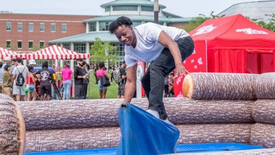 sophomore computer science major, Tyler McFarland, tries the mechanical surfboard