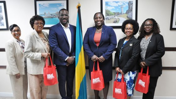 Vice Chancellor Reggie Hill stands with Chilean Burrows and other members of The Bahamas Ministry of Education and Technical and Vocational Training
