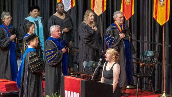 Kerstin Dolejsi, an undergraduate student in the College of Arts and Sciences, performs the National Anthem during the ceremony for the College of Business Administration and UMSL/Washington University Joint Undergraduate Engineering Program on Friday evening at the Mark Twain Athletic Center